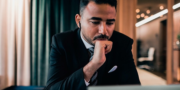 Businessman looking at laptop while sitting